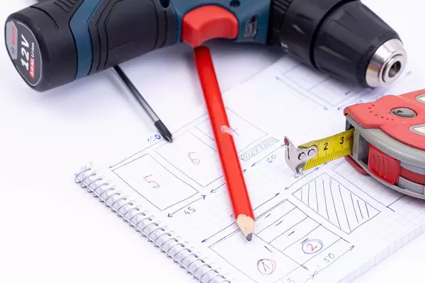 Bosch battery drill with Measuring Tape and Screwdrivers on the project sketch