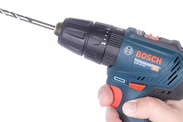 Bosch Drill in the hand with large drill above white background