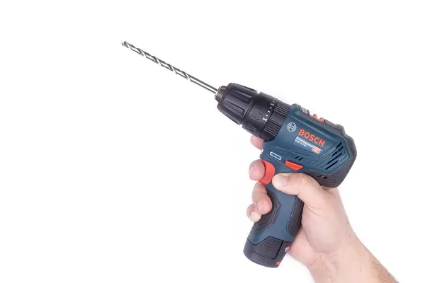 Bosch Drill in the hand with large drill with copy space