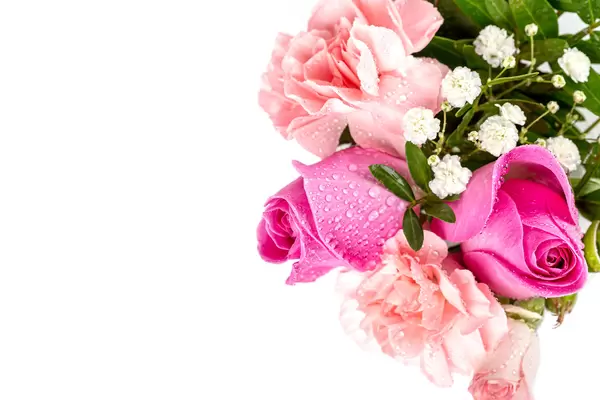 Bouquet of flowers - roses and carnations with water drops on a white background, top view