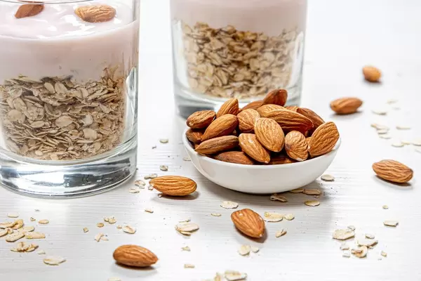 Bowl full of almonds and oatmeal porridge behind (Flip 2019)