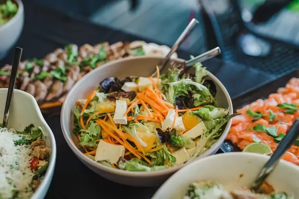 Bowl Of Camambert Cheese and Tangerine Salad With Greens