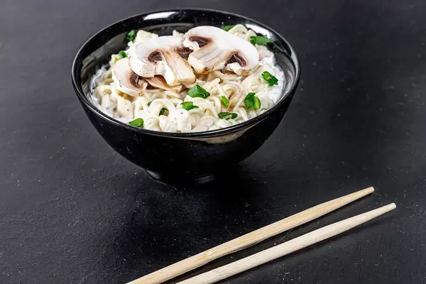 Bowl of cheese and mushroom soup with pasta and herbs (Flip 2019)