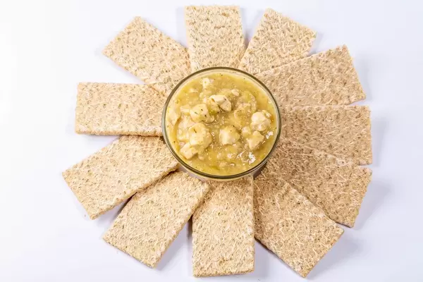 Bowl of oatmeal with chicken meat and diet breads around. The concept of diet
