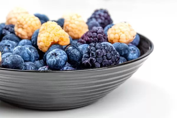 Bowl with blueberries, yellow raspberries and mulberries