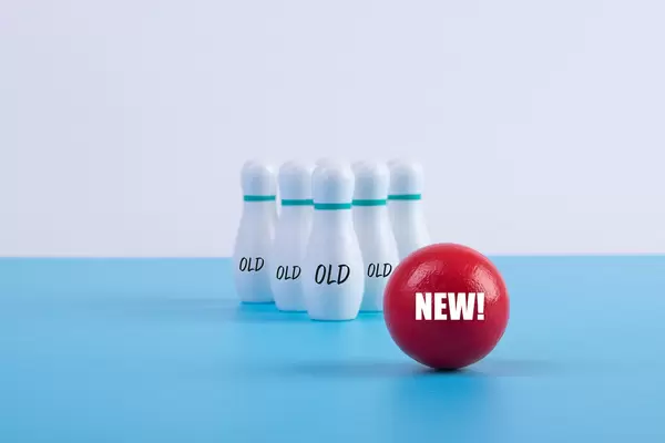Bowling pins with Old text and bowling ball with New text