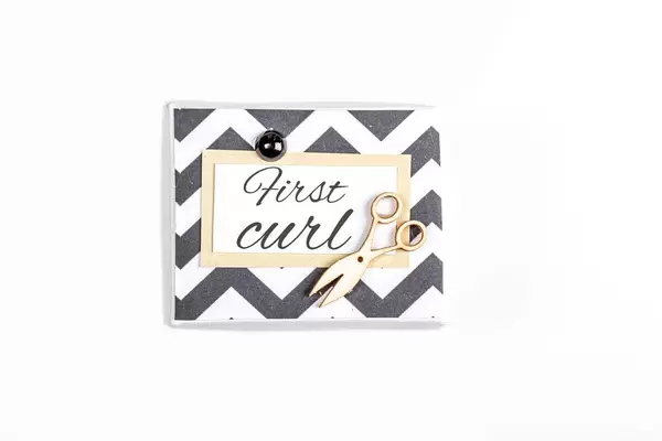 Box for the first curl of the baby on a white background