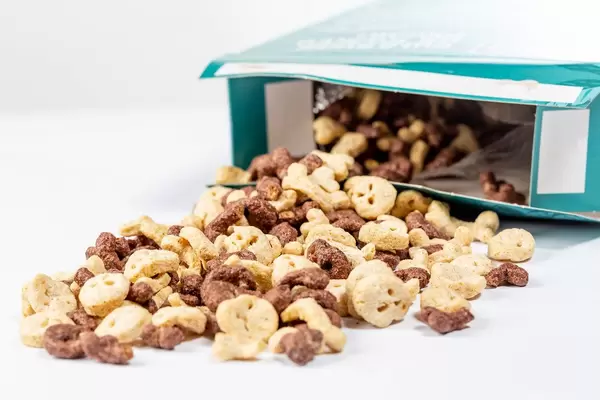 Box of cornflakes for kids in the shape of skulls and bones on white background