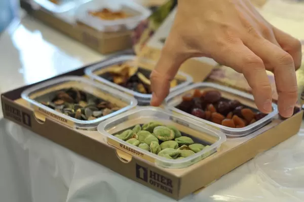 Box with dried fruit, pumpkin seeds and wasabi peanuts