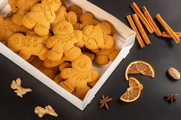 Box with gingerbread on a dark background with winter spices