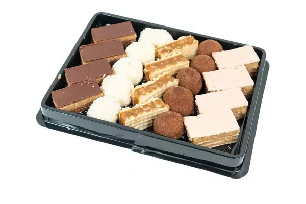 Box with mixed chocolate cookies isolated above white background