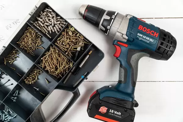 Box with screwdrivers and Accu Drill on the wooden background