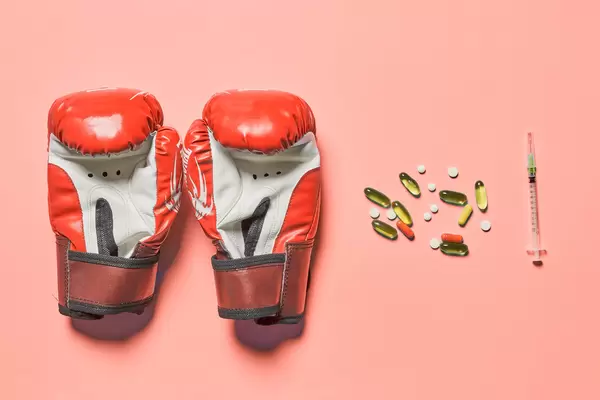 Boxing gloves and stimulating sport drugs capsules and syringe with doping