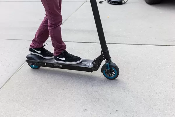 Boy tries out the innovative Egret One electroscooter at the E-Cologne trade show