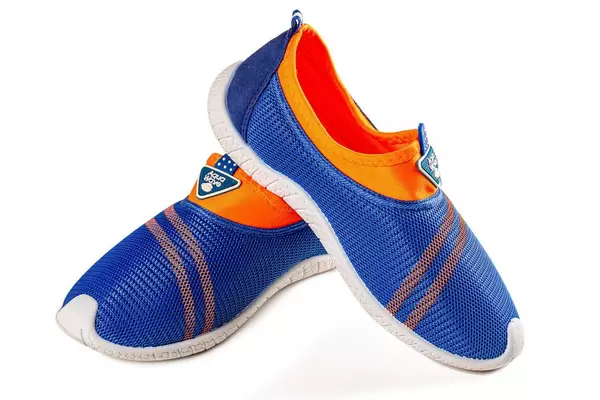 Boyish casual sports sneakers of blue-orange color on white background