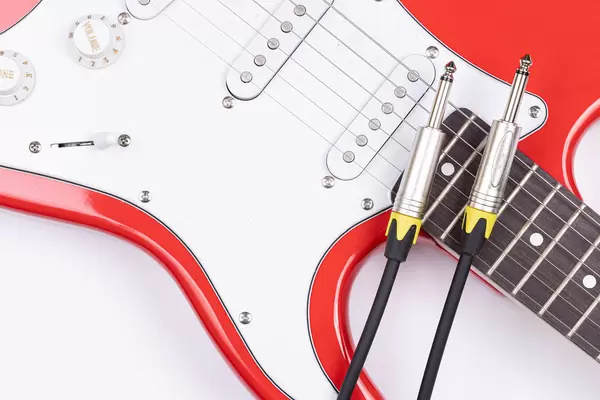 Brand New Electric Guitar with audio cables on it