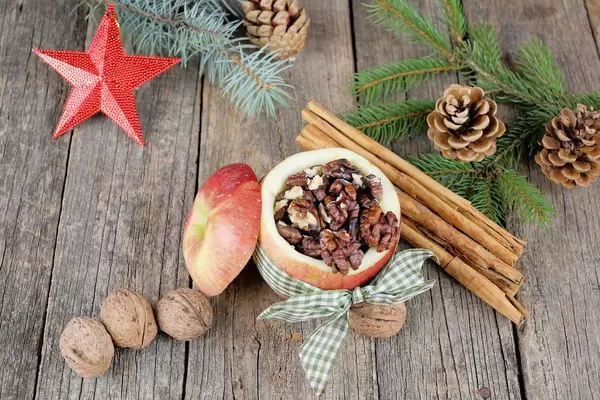 Bratapfel, baked apples on wooden background