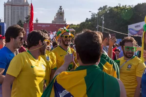 Brazilian soccer fans with goofy sunglasses and jester hats