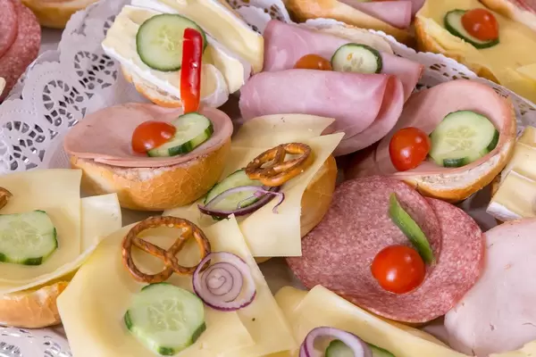 Bread rolls with cheese, salami and ham with tomatoes and cucumbers