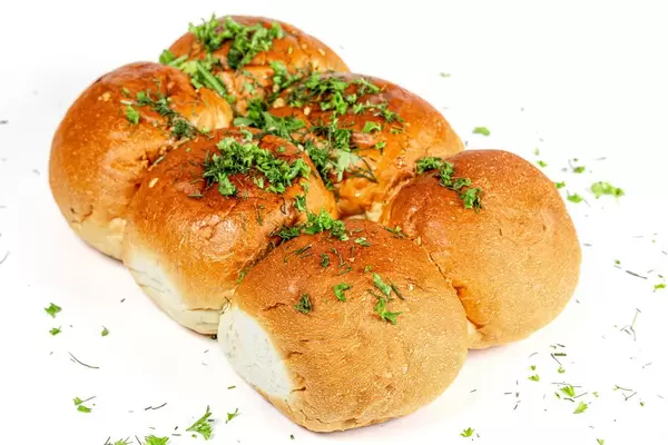 Bread with chopped parsley and dill with garlic on a white