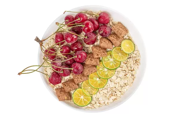 Breakfast oatmeal with cherries, corn pads and calamondin