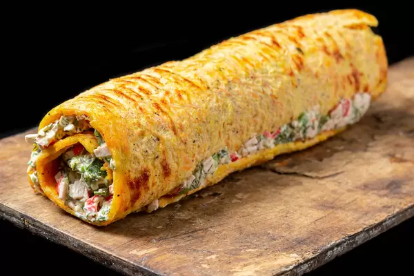 Breakfast roll-ups with omelet, crab sticks and herbs