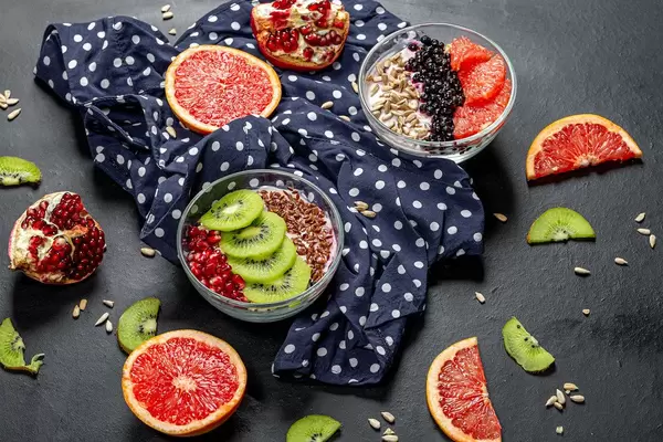 Breakfast with fresh fruit, oatmeal and seeds. Top view (Flip 2019)