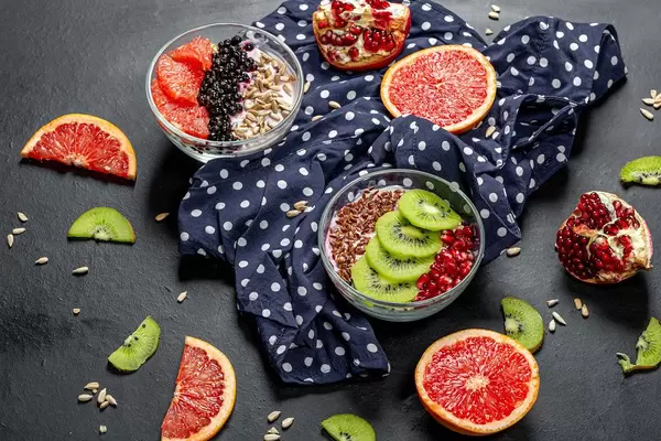 Breakfast with fresh fruit, oatmeal and seeds. Top view