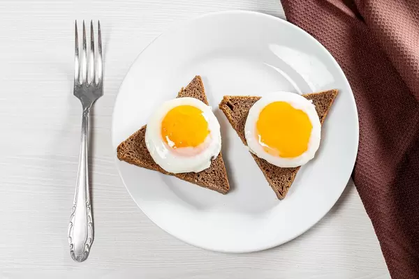Breakfast with fried eggs and black bread. Top view (Flip 2019)