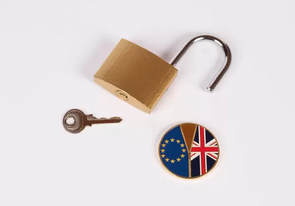 Brexit medal coin with open padlock and key on white background (Flip 2019)