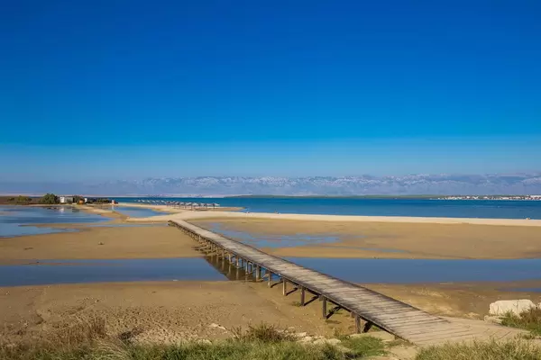 Bridge to sandy beach