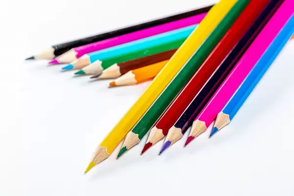 Bright colored pencils on white background. The concept of preparation for school