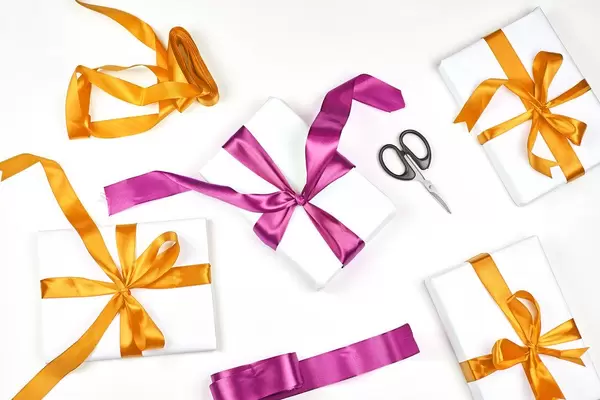 Bright handmade DIY Christmas presents decorated with colorful textile ribbons