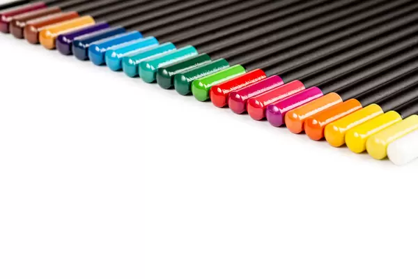 Bright palette of colored pencils on white