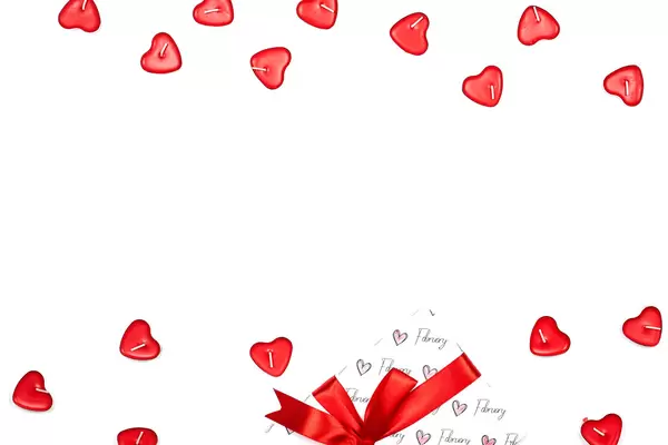 Bright Valentine's day background with heart-shaped candles and giftbox