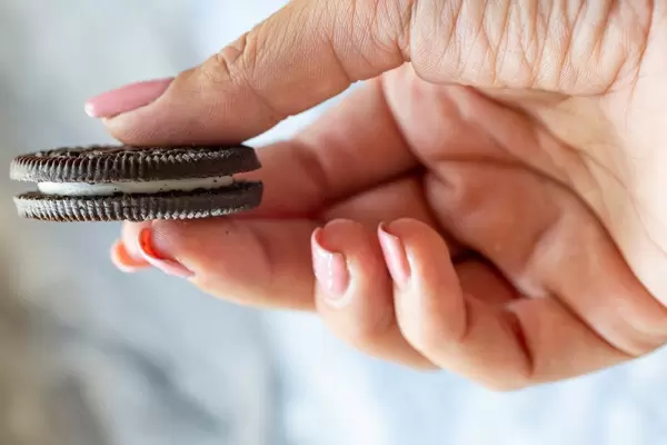 Brown cookies in a woman's hand (Flip 2019)