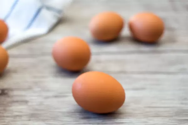 Brown egg Close -up on a wooden background