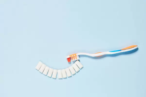 Brushing symbolic teeth with toothbrush