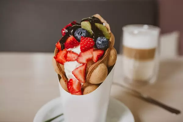 Bubble waffle With strawberries close up (Flip 2019)