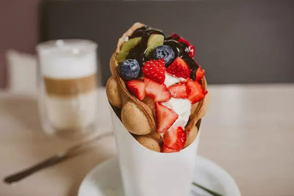 Bubble waffle With strawberries close up