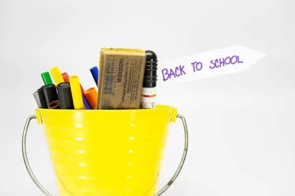 Bucket with color pens and tag reading "Back to School"
