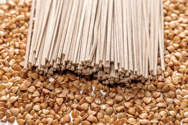 Buckwheat noodles soba on the background of raw buckwheat (Flip 2019)