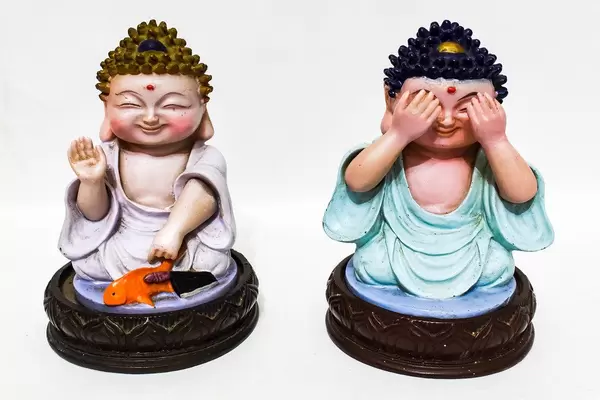 Buddha figurines isolated on white surface (Flip 2019)