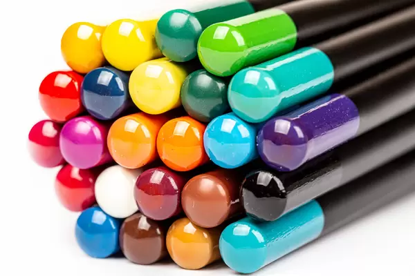 Bundle of multicolored pencils on white, close-up