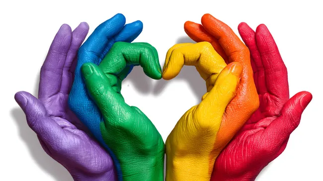 Bunte Hände formen Herzsymbol als LGBT-Zeichen