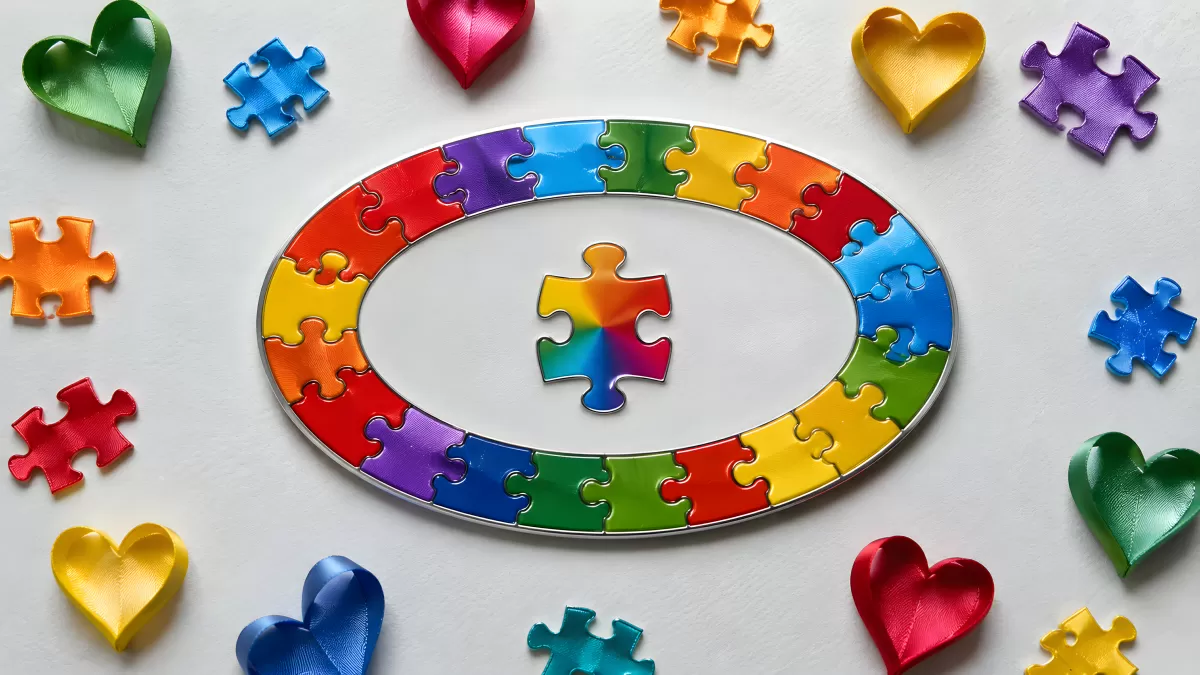 Bunte Puzzle-Teile und Herzen in Regenbogenfarben
