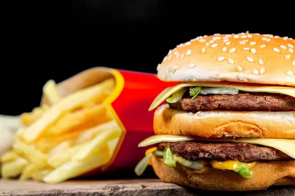 Burger and fries on dark background