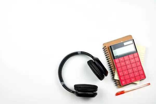 Business flat lay with copy space. Red calculator, pen and notepad on white background