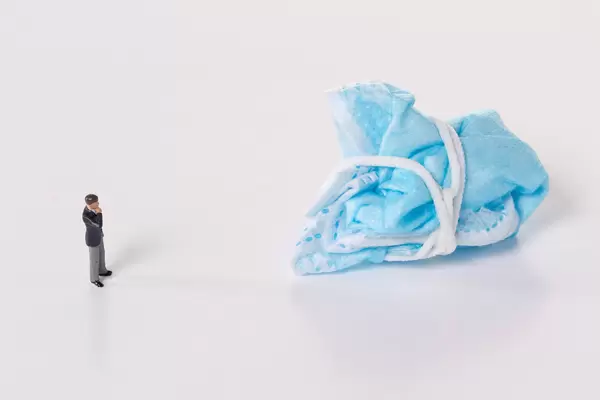 Businessman and used face mask