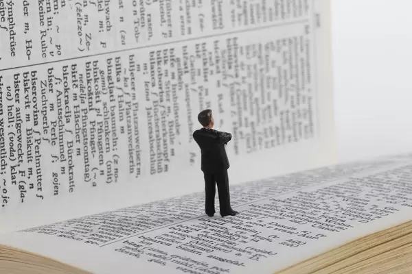 Businessman figure standing on book